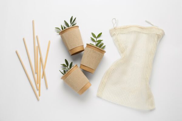Paper,Cups,With,Green,Twigs,,Mesh,Bag,And,Bamboo,Straws
